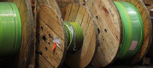 Large reels of green and yellow striped cable