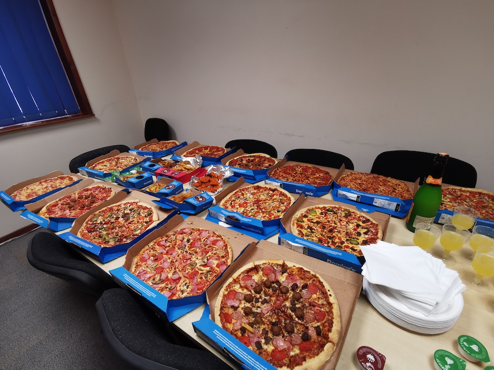 A table laden with pizza and other goodies