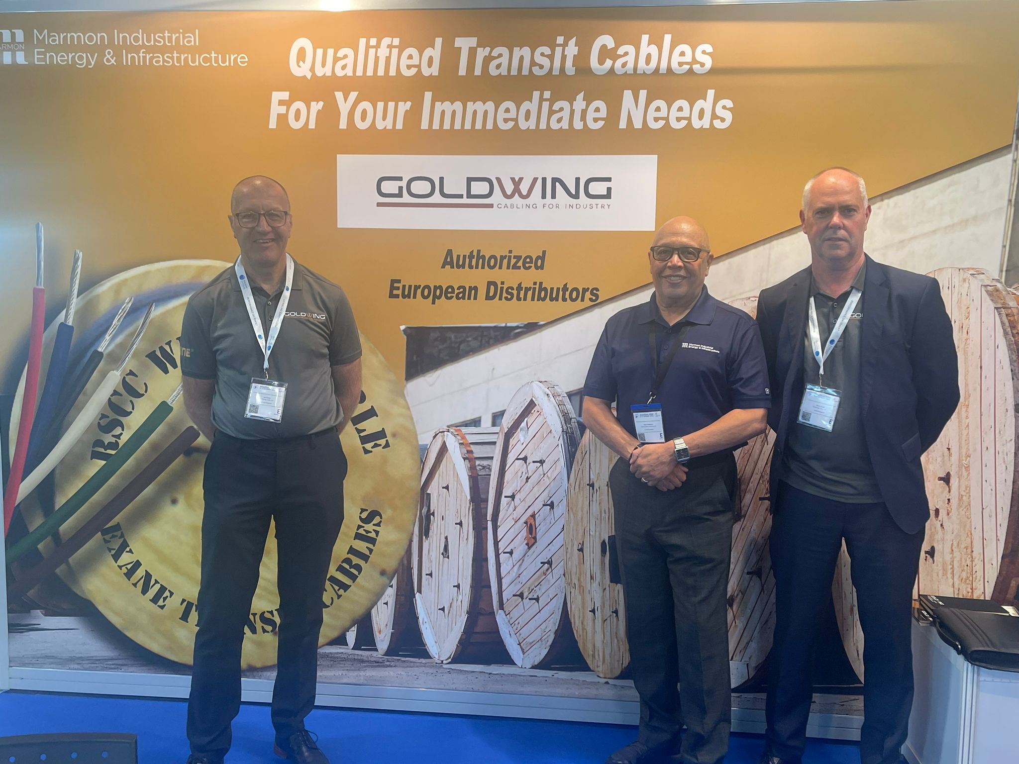 Staff standing in front of the Goldwing logo at InnoTrans 2024